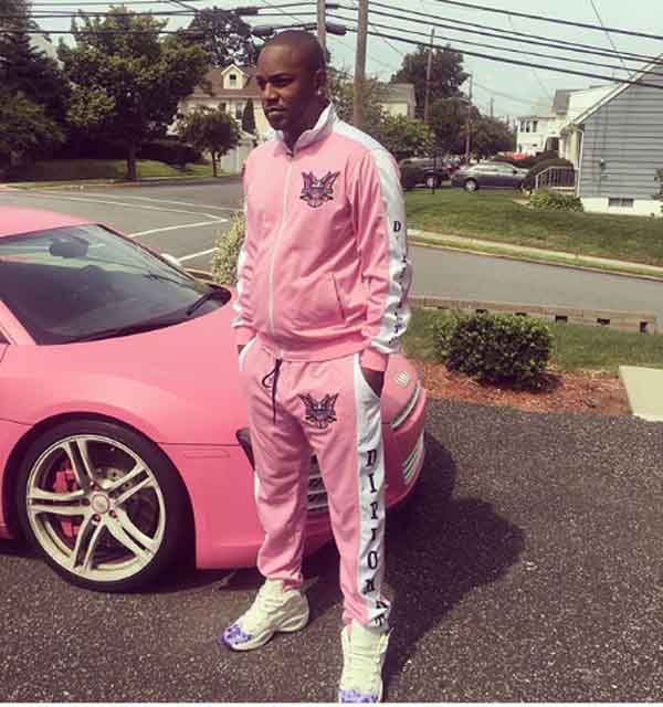 Cam'ron taking picture with his car.
